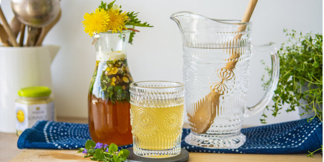 Oxymel | © SONNENTOR Auf dem Foto sieht man eine Karaffe mit Wildkräuter Oxymel, eine weitere mit Wasser und ein Glas. | © SONNENTOR
